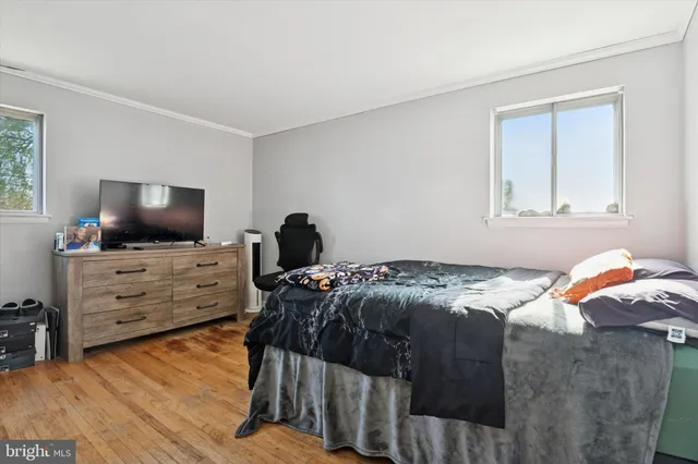 a bedroom with a bed and flat screen tv