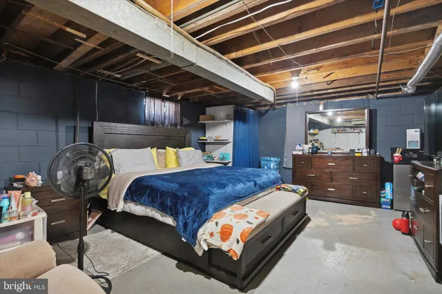 a bedroom with bed and utility