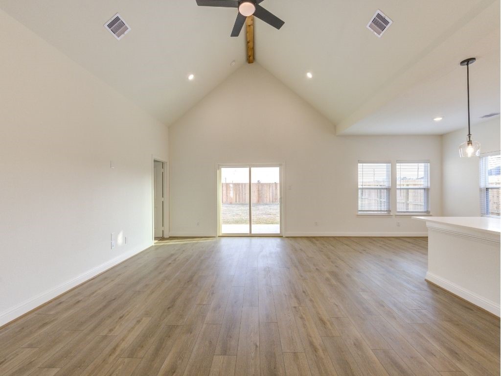 140 County Road 2278 Cleveland, TX 77327 - Photo 3 of 10 an empty room with wooden floor and windows