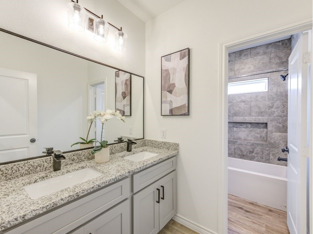 140 County Road 2278 Cleveland, TX 77327 - Photo 6 of 10 a bathroom with a granite countertop sink mirror vanity and a bathtub