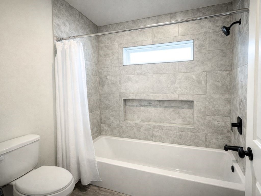 140 County Road 2278 Cleveland, TX 77327 - Photo 8 of 10 a white bath tub sitting next to a white toilet