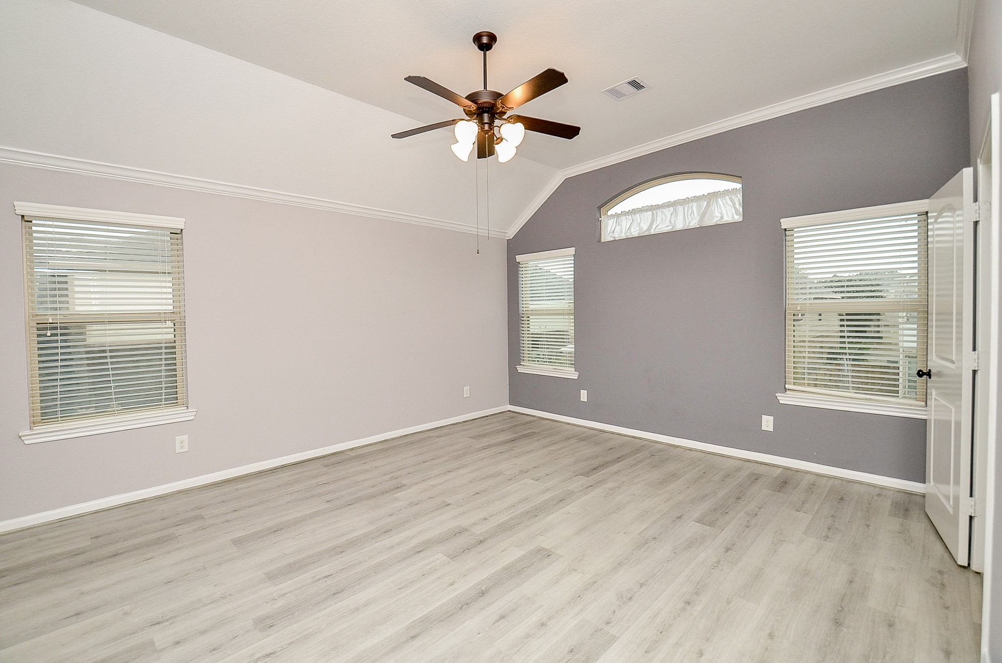 1510 Kent Valley Lane Rosenberg, TX 77471 - Photo 22 of 33 an empty room with wooden floor fan and windows