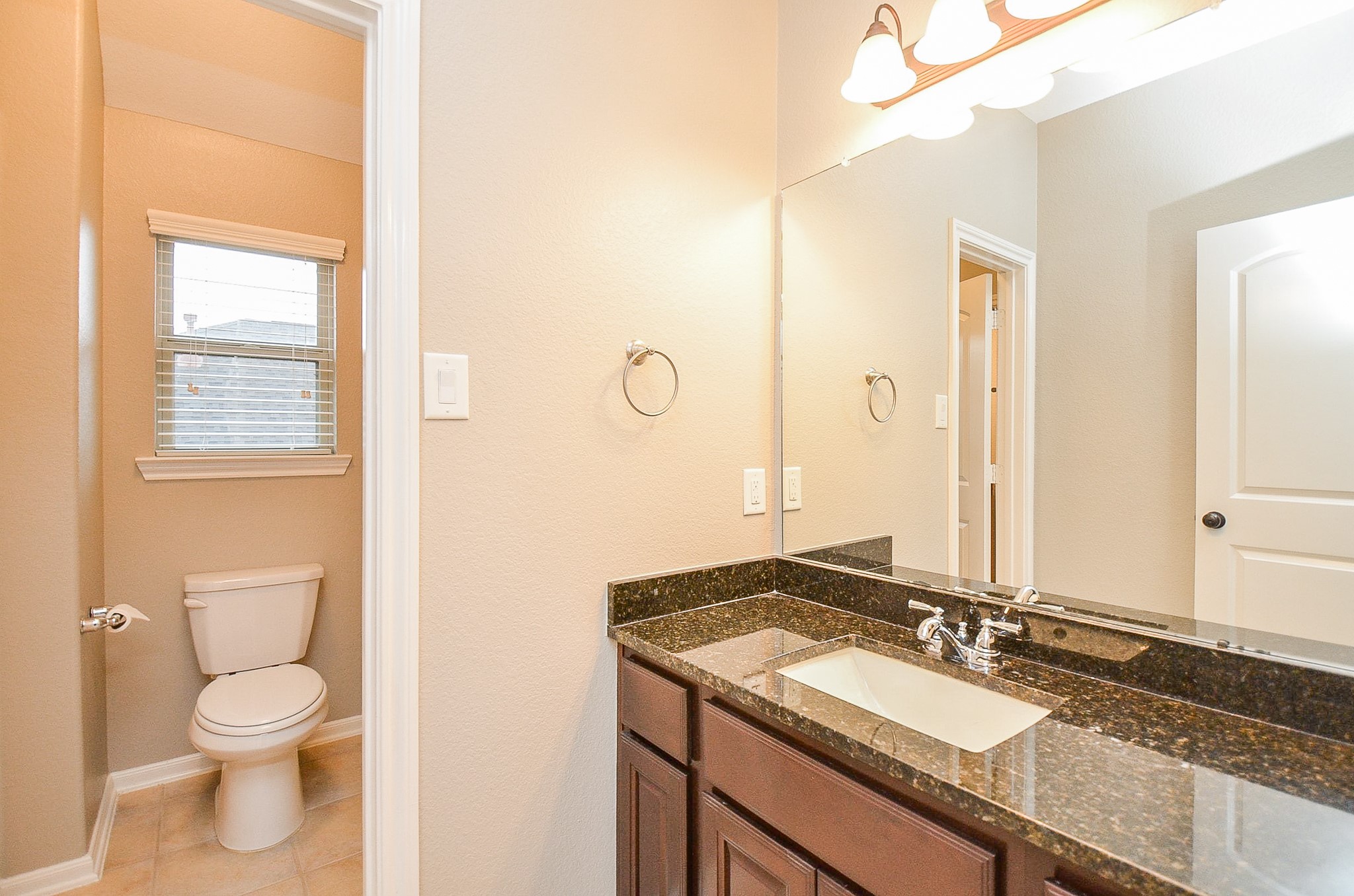 1510 Kent Valley Lane Rosenberg, TX 77471 - Photo 27 of 33 a bathroom with a granite countertop sink toilet and mirror