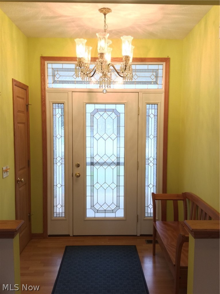 3400 Church Road Medina, OH 44256 - Photo 2 of 24 ENTRY FOYER WITH BEVELED/LEADED GLASS DOOR & SIDELIGHTS SET OFF WITH AN ANTIQUE CRYSTAL CHANDELIER.