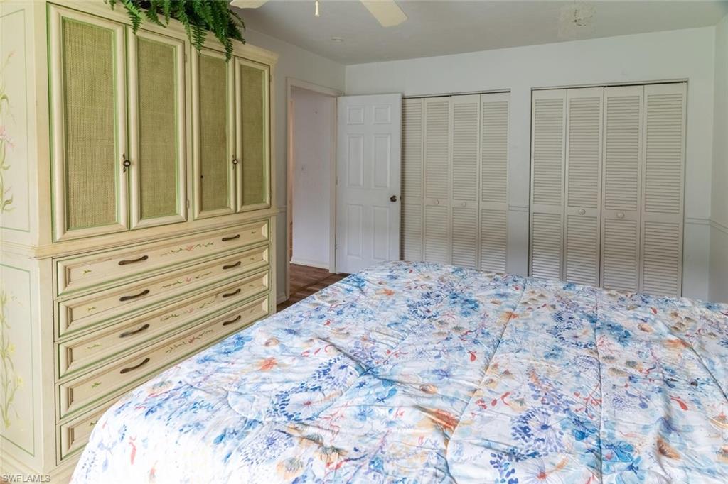 1031 Ridge Street Naples, FL 34103 - Photo 22 of 38 Bedroom featuring two closets and ceiling fan