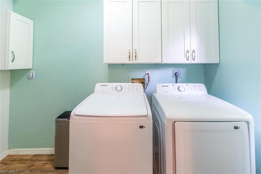 1031 Ridge Street Naples, FL 34103 - Photo 10 of 38 Clothes washing area featuring independent washer and dryer, and cabinets. It is off of the Kitchen