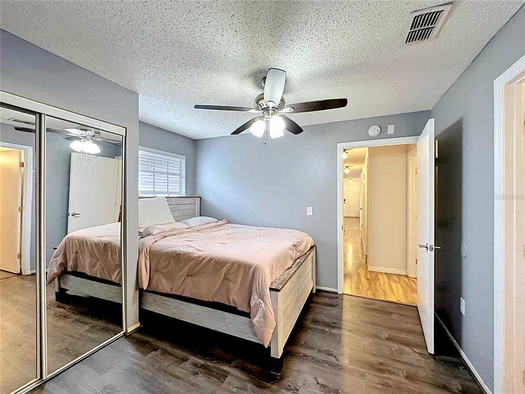 3705 Southwest 27th Street, Unit 922 Gainesville, FL 32608 - Photo 15 of 34 a bedroom with a large bed and a chandelier