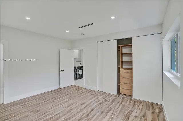 a view of wooden floor and windows in a room