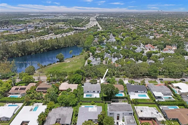 an aerial view of residential houses with outdoor space and river