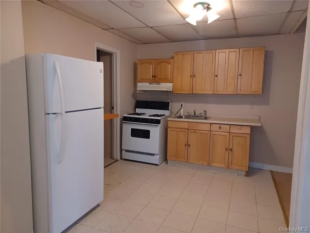 a kitchen with a stove sink and refrigerator
