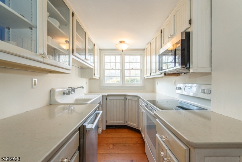 111 Main Street Succasunna, NJ 07876 - Photo 34 of 45 a kitchen with granite countertop a sink a stove and cabinets