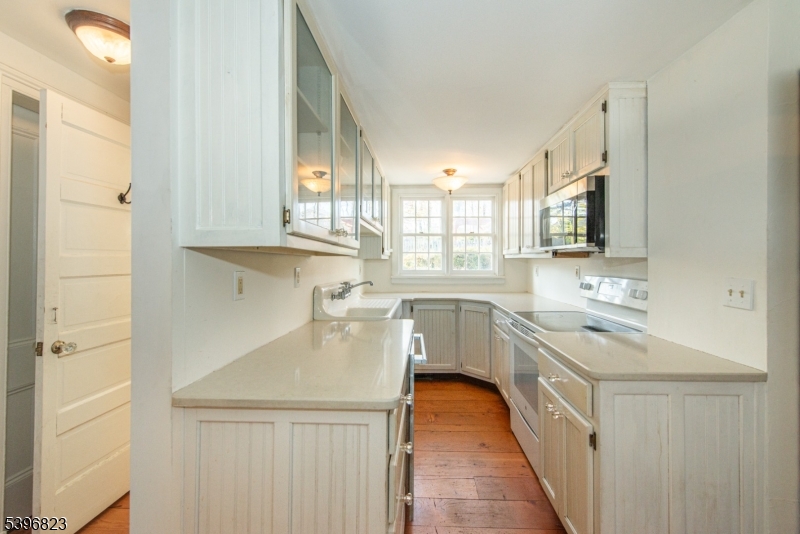 111 Main Street Succasunna, NJ 07876 - Photo 35 of 45 a kitchen with a sink a stove a refrigerator and cabinets
