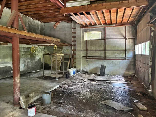 a view of a backyard with table and chairs under an umbrella