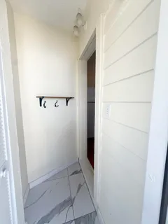 a view of a livingroom with a fireplace a ceiling fan and wooden floor