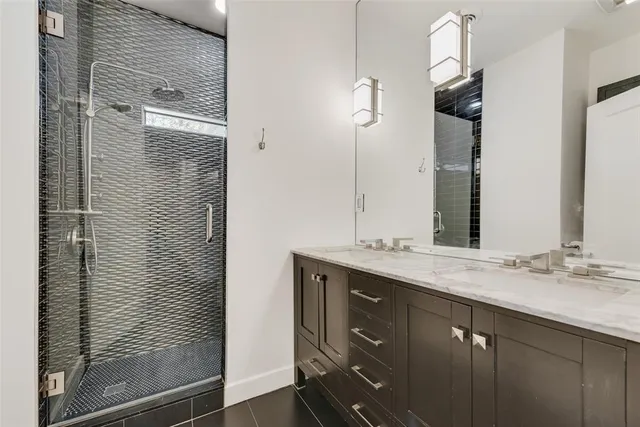 a bathroom with a shower and a sink