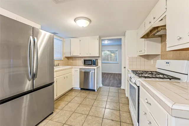 a kitchen with a stove a sink and a refrigerator
