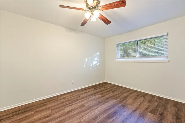 wooden floor in an empty room with a window