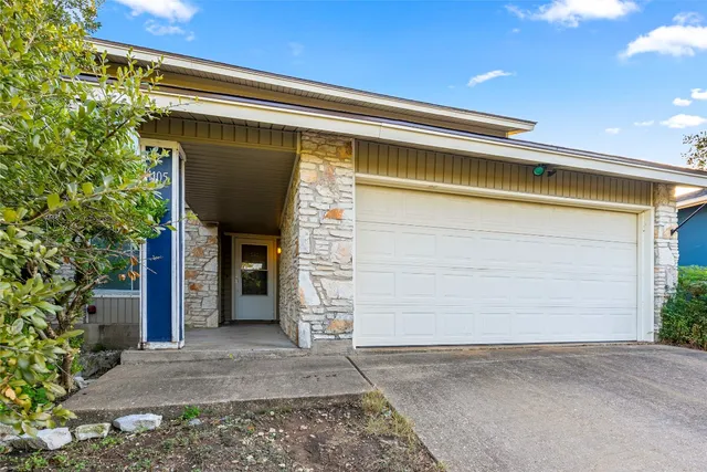 a front view of a house with a garage