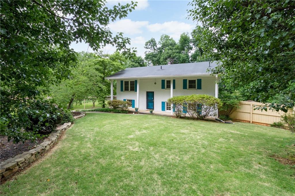 2089 Mulkey Road Southwest Marietta, GA 30008 - Photo 1 of 1 a view of a house with backyard sitting area and garden