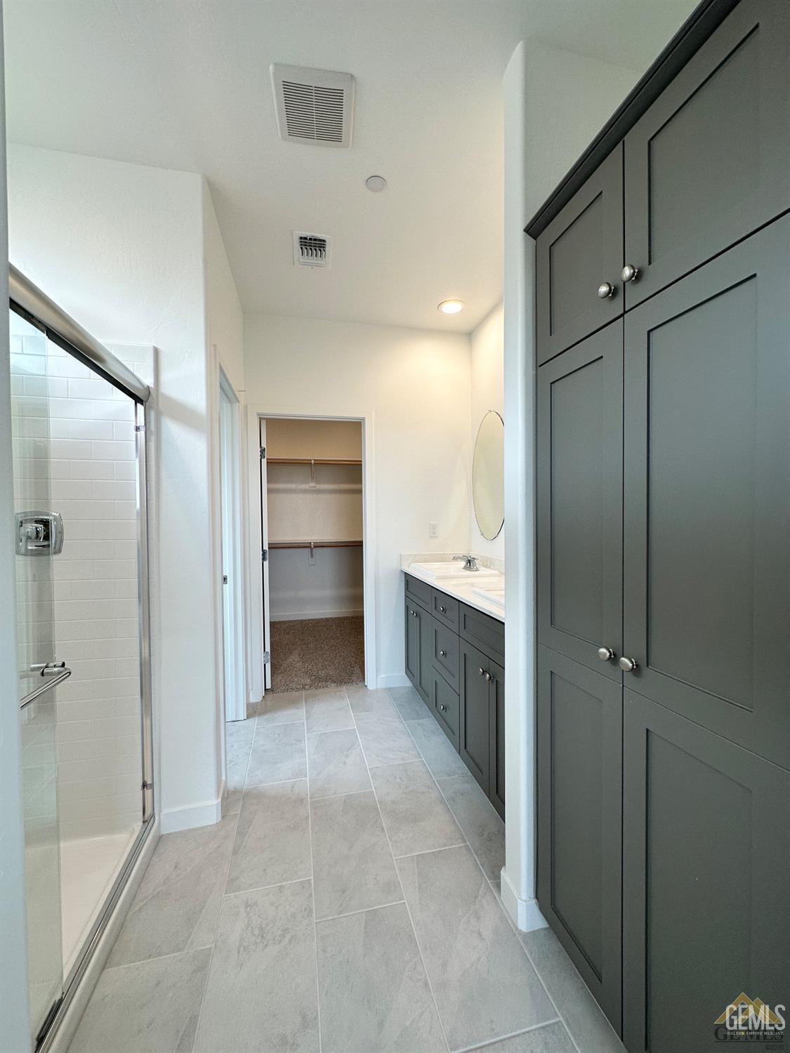 Undisclosed Address Bakersfield, CA 93311 - Photo 3 of 7 a bathroom with a double vanity sink a toilet and shower