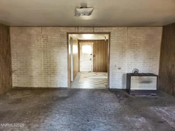 a view of a hallway with brick walls