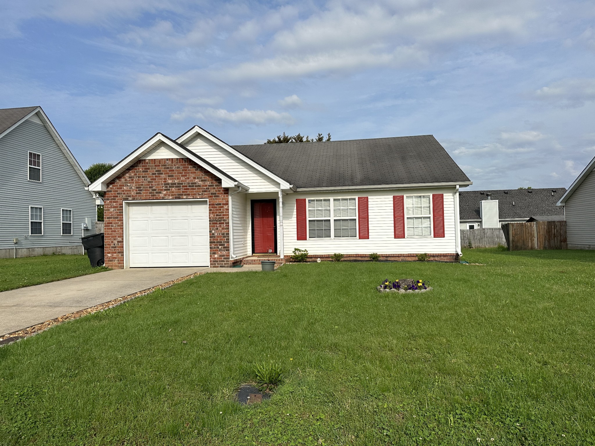 a front view of a house with a garden