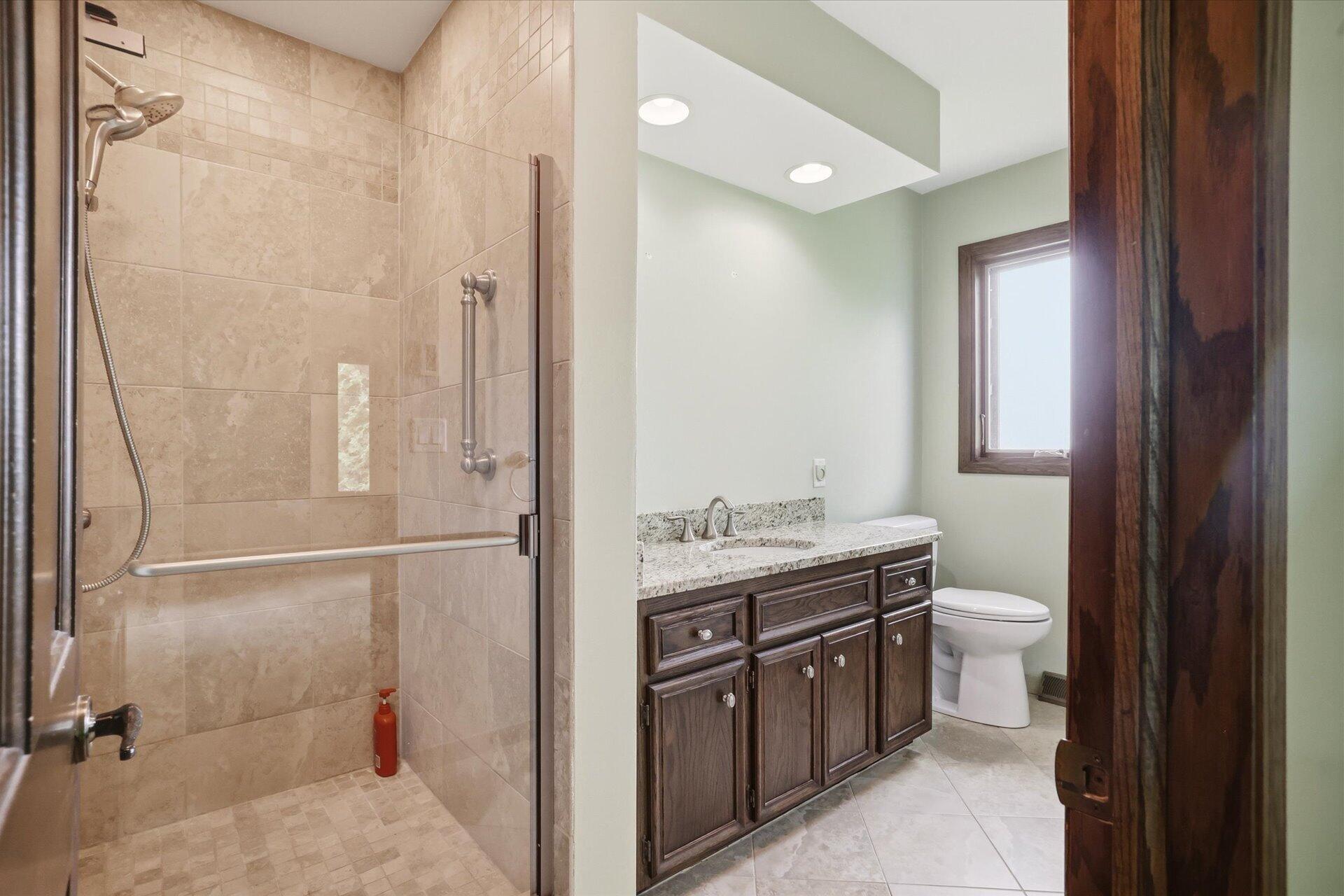 4100 South 119th Street Greenfield, WI 53228 - Photo 12 of 31 Tile shower tile heated floor and granite vanity top!