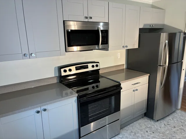 a kitchen with a refrigerator stove and microwave