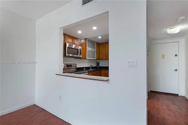 a view of kitchen with sink and microwave