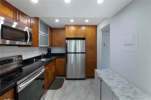 a kitchen with a refrigerator and a microwave