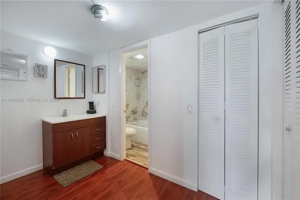 a spacious bathroom with a sink a mirror and a bathtub