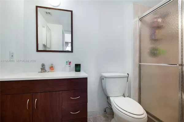 a bathroom with a toilet a sink a vanity and mirror