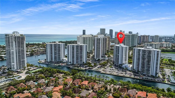 a view of a wrought iron fences in front of buildings