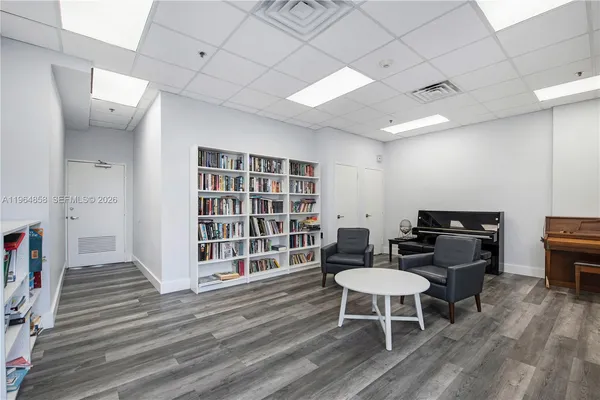 a view of a dining room with furniture a rug and wooden floor