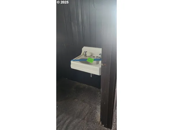 a view of an empty room with floor and a window