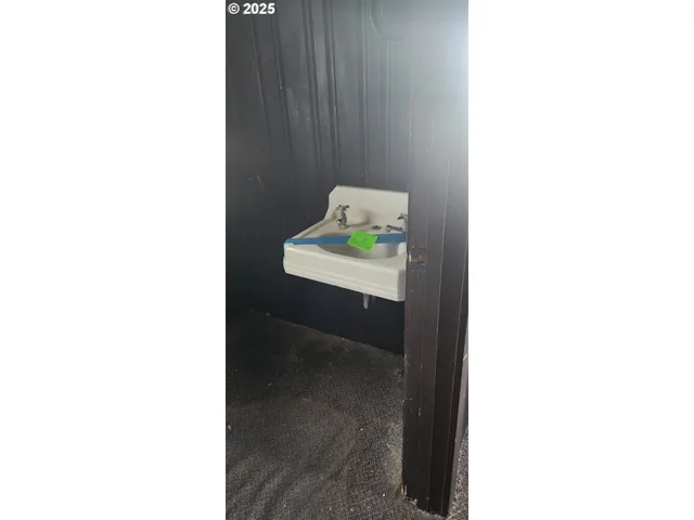 a view of an empty room with floor and a window