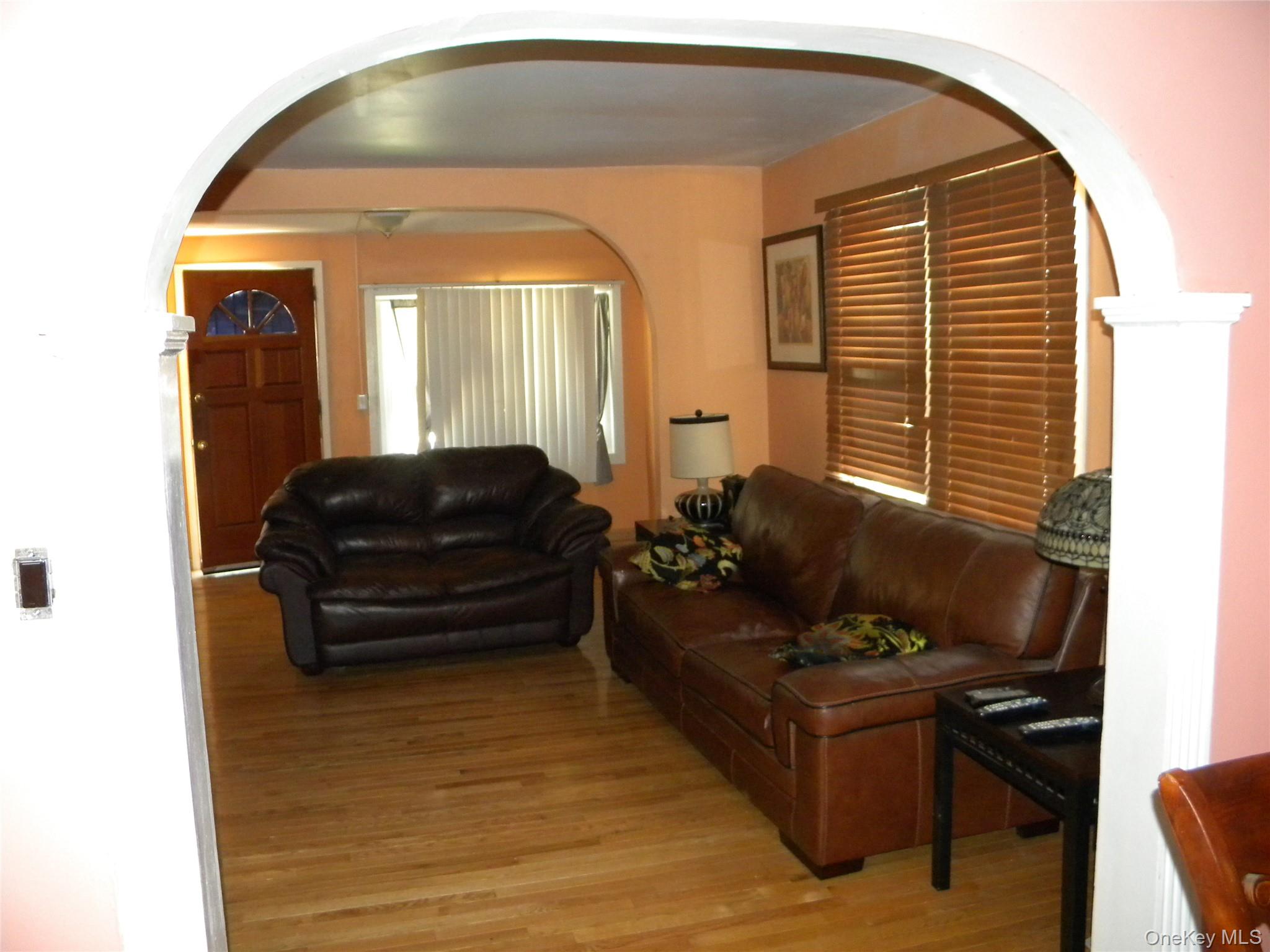 241-26 86th Road Queens, NY 11426 - Photo 8 of 38 a living room with furniture and a window