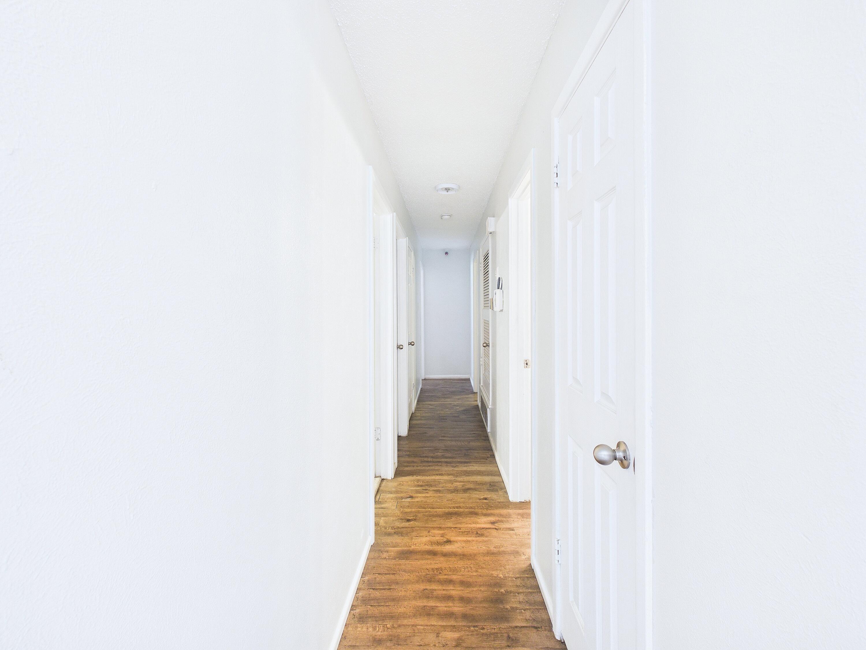 4825 10th Street Lubbock, TX 79416 - Photo 13 of 27 a view of a hallway with wooden floor