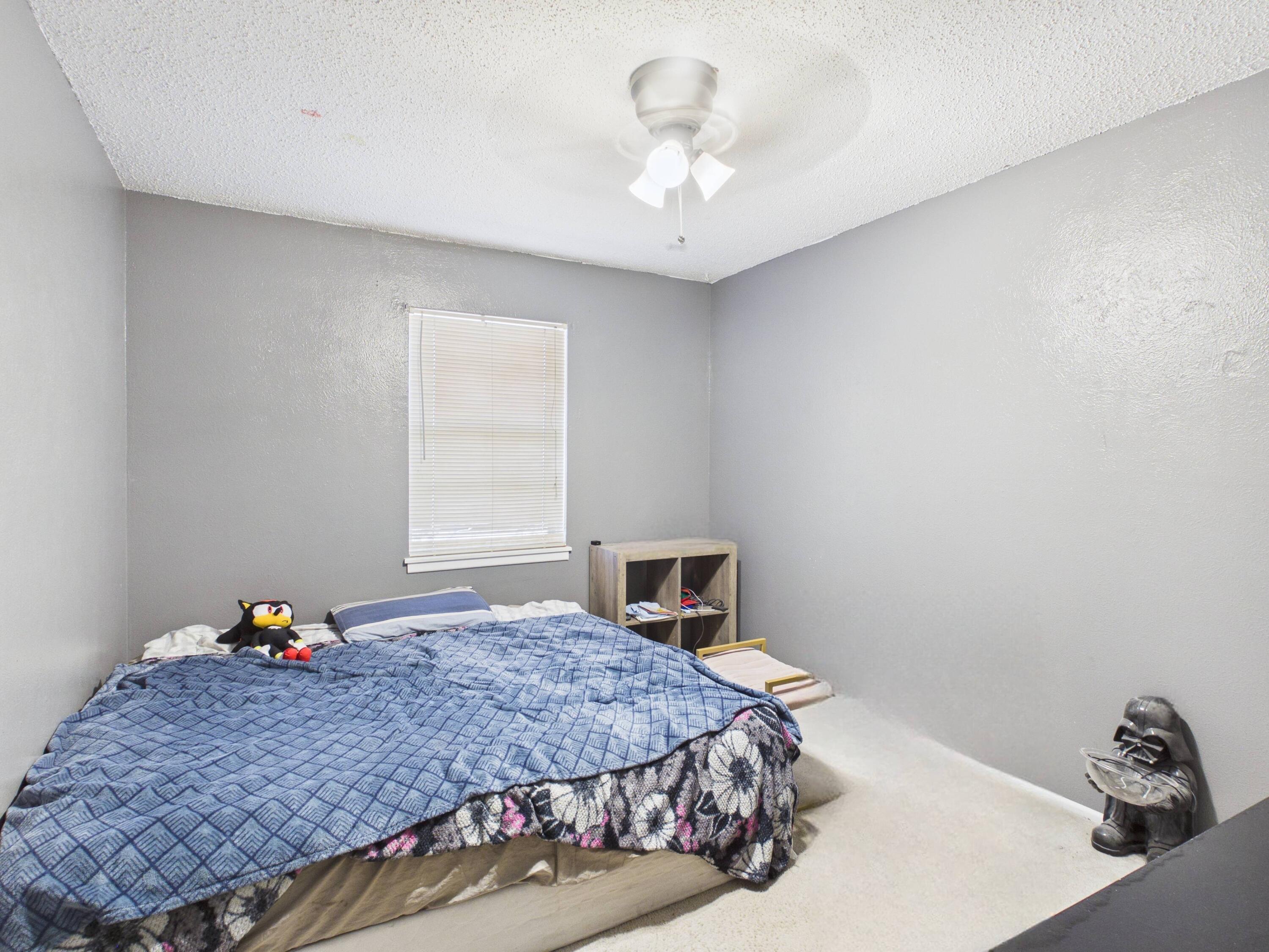 4825 10th Street Lubbock, TX 79416 - Photo 22 of 27 a bedroom with a bed and a window