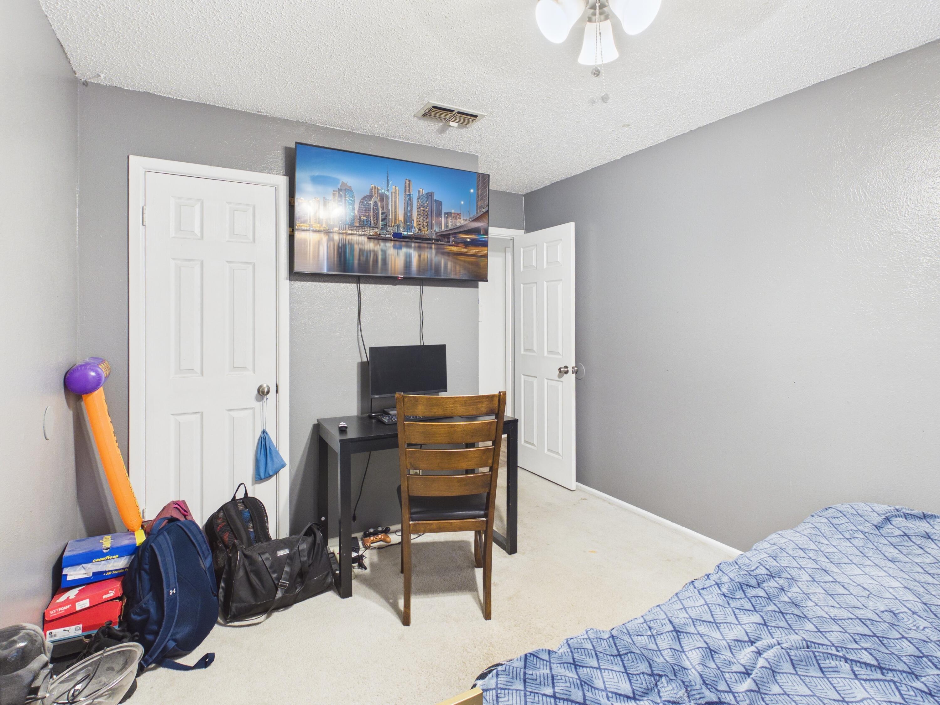 4825 10th Street Lubbock, TX 79416 - Photo 23 of 27 a bedroom with furniture and a bed