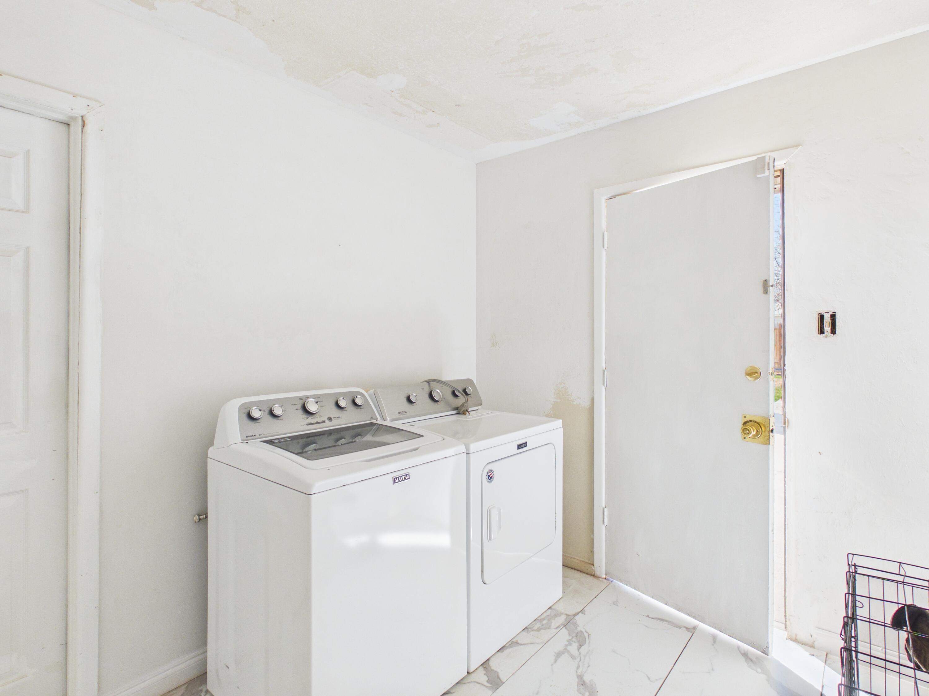 4825 10th Street Lubbock, TX 79416 - Photo 24 of 27 a utility room with dryer and washer