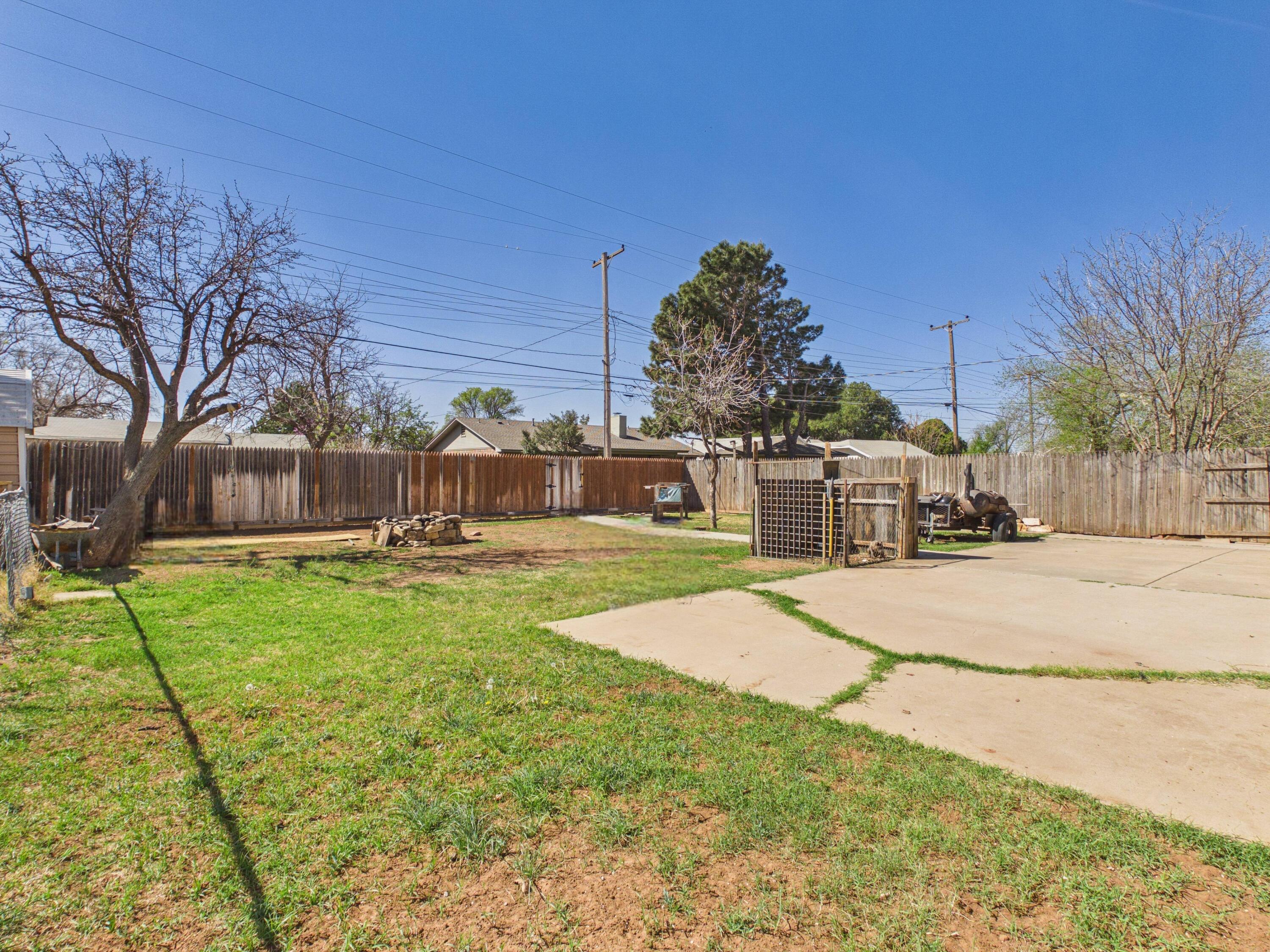4825 10th Street Lubbock, TX 79416 - Photo 26 of 27 a view of a house with backyard and a tree