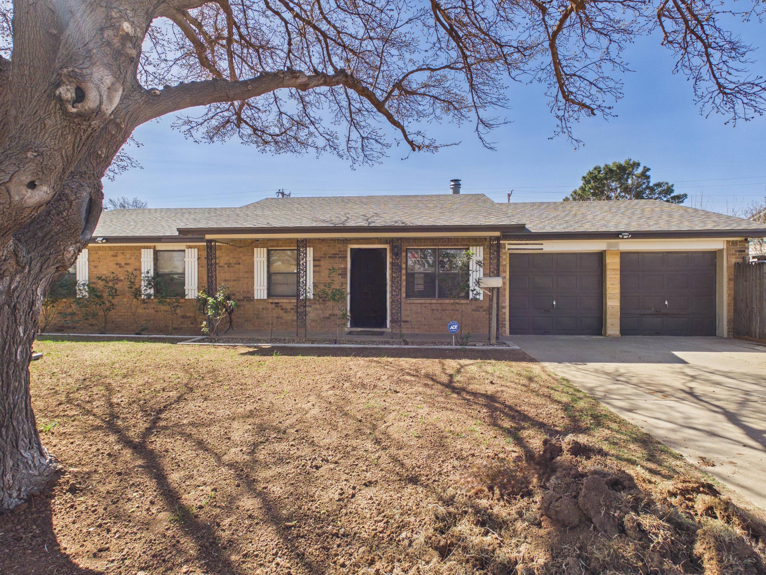 4825 10th Street Lubbock, TX 79416 - Photo 4 of 27 front view of a house with a yard