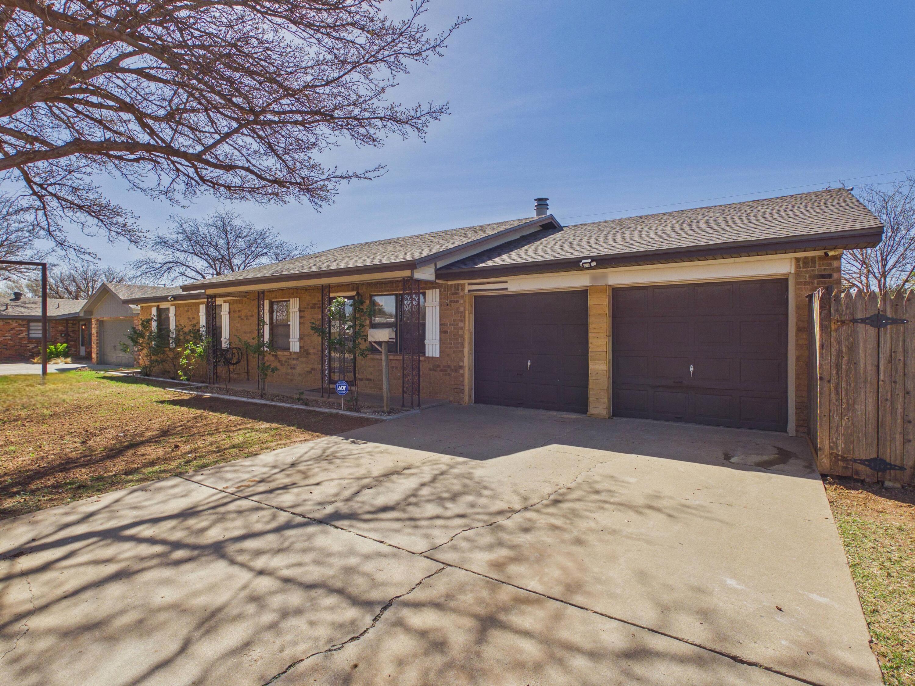4825 10th Street Lubbock, TX 79416 - Photo 5 of 27 a view of yellow house with a yard