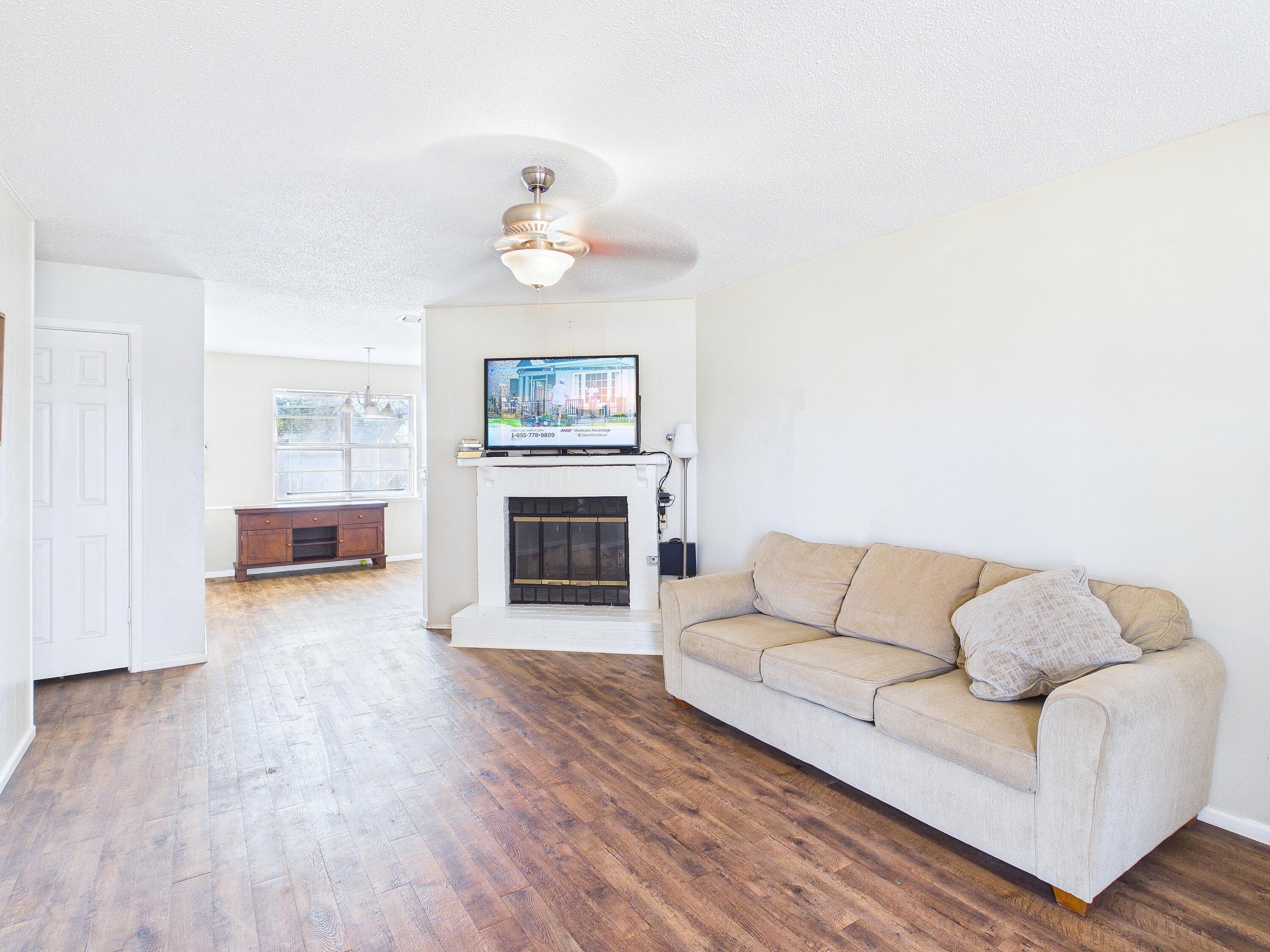 4825 10th Street Lubbock, TX 79416 - Photo 7 of 27 a living room with furniture and a fireplace