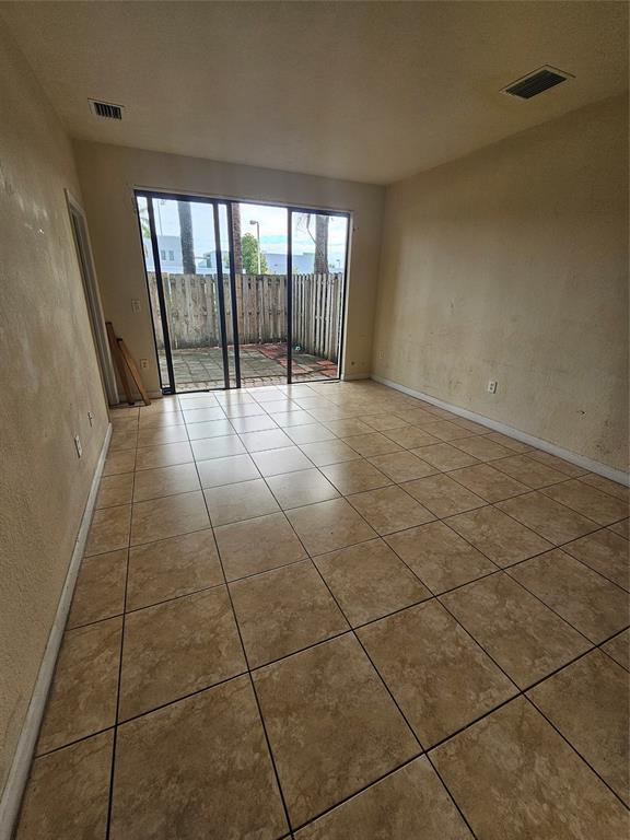 23519 Southwest 112th Court Homestead, FL 33032 - Photo 13 of 19 a view of an empty room and glass door