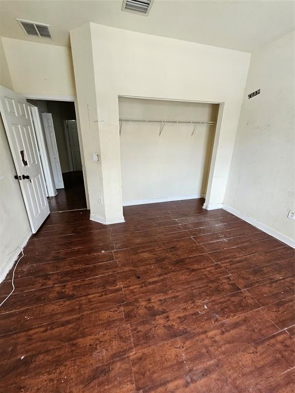 23519 Southwest 112th Court Homestead, FL 33032 - Photo 17 of 19 a view of an empty room with wooden floor and a window