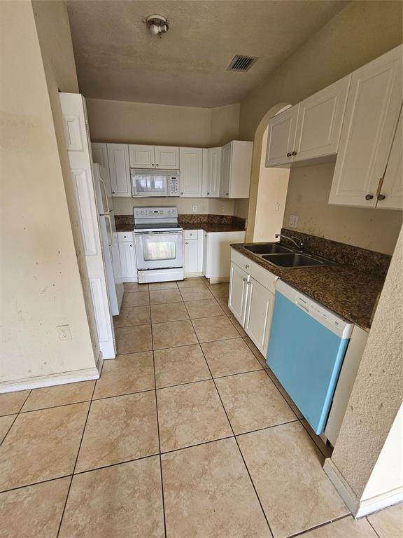 23519 Southwest 112th Court Homestead, FL 33032 - Photo 2 of 19 a kitchen with stainless steel appliances granite countertop a stove a sink and a microwave