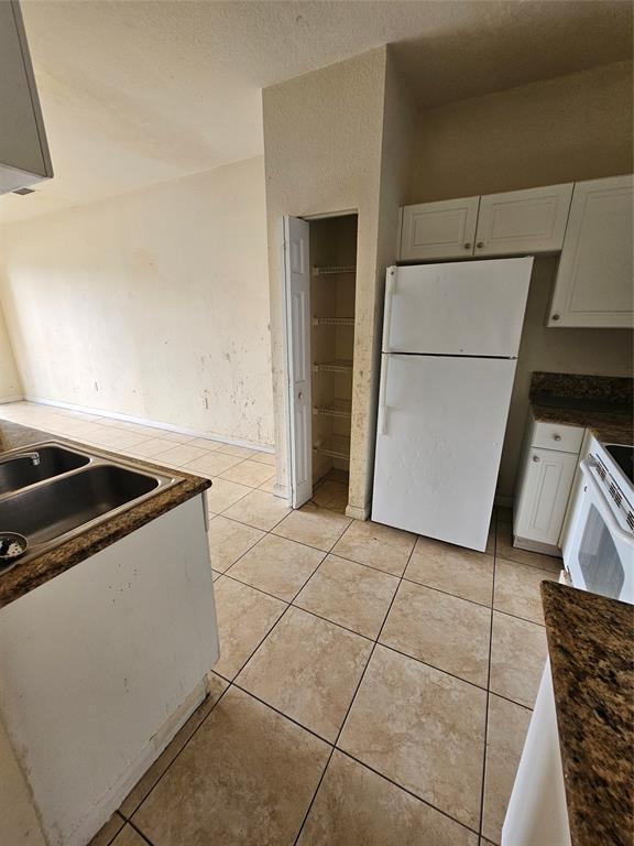 23519 Southwest 112th Court Homestead, FL 33032 - Photo 3 of 19 a kitchen with a stove a refrigerator and a sink