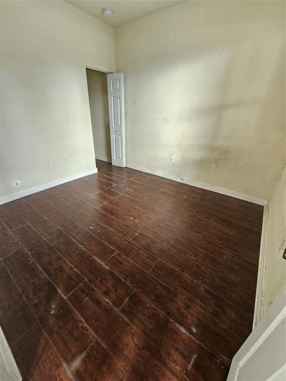 23519 Southwest 112th Court Homestead, FL 33032 - Photo 7 of 19 an empty room with wooden floor